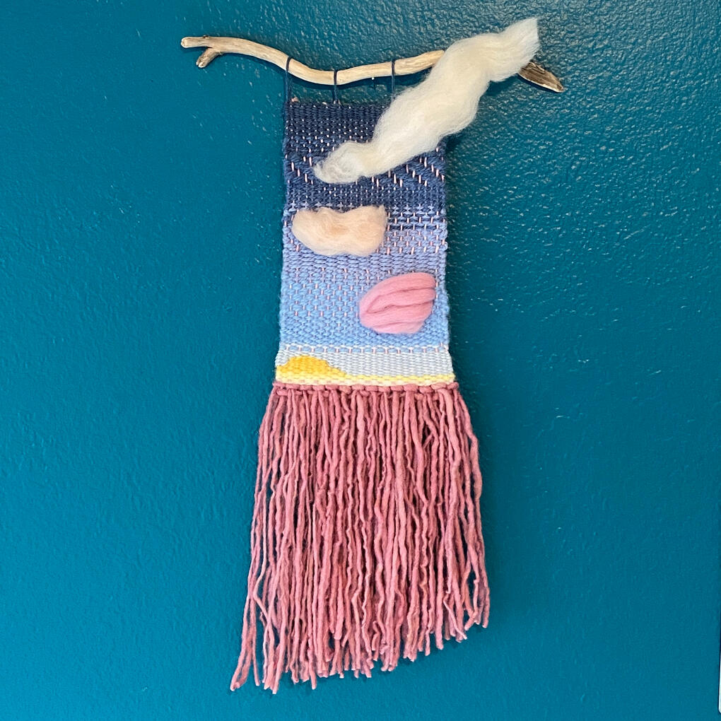 Wonderberry Sunset A weaving evoking a cloudy sunset using hand-died pink yarn.
