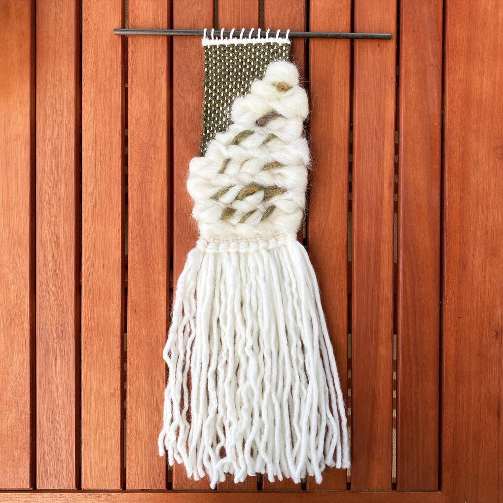 Cait A textural green yarn and undyed roving weaving.